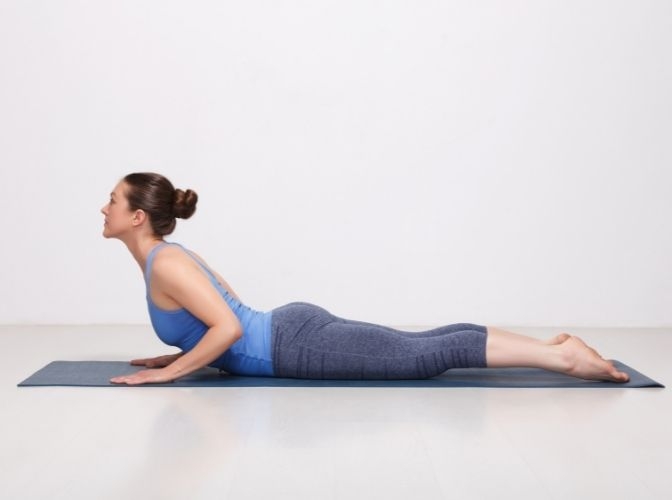woman in half cobra pose