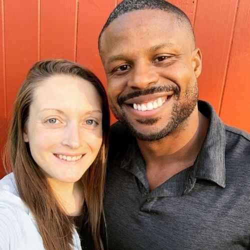 Antonio and wife with red barn in the background
